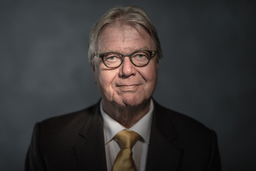 Senior businessman on dark background