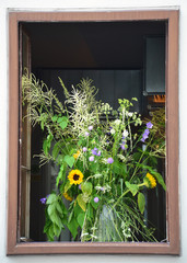 Fototapeta na wymiar Old window with flowers