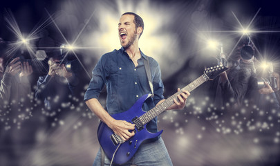 handsome young man playing electric guitar
