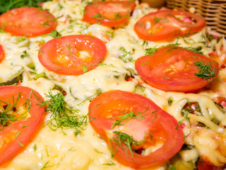 Italian meat pizza with tomatoes and herbs