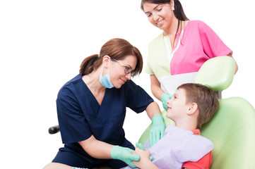 Stomatologist doctor with assistant and child patient