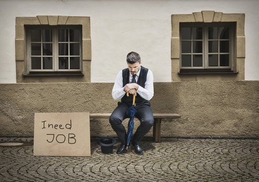 Sad Businessman Sitting on Bench After He Lost His Job-Job Loss Concept