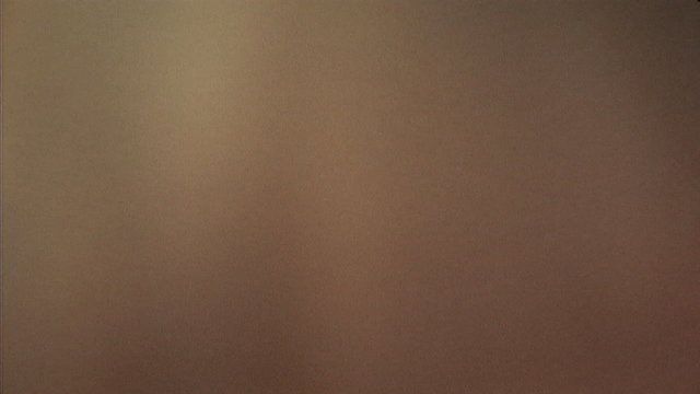 Woman taking off blouse and climbing spiral staircase