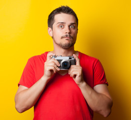guy in t-shirt with retro camera