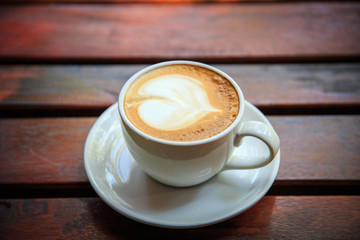coffee latte art on the wood desk at coffee shop