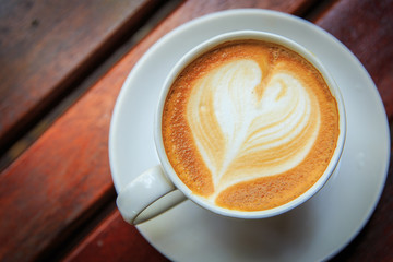 coffee latte art on the wood desk at coffee shop