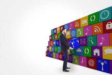 Unsmiling businessman holding something with his hands