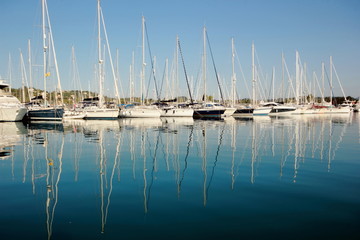 reflections yachts and boats in a marina 