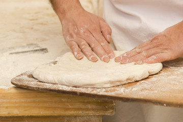 Hands of a baker kneading