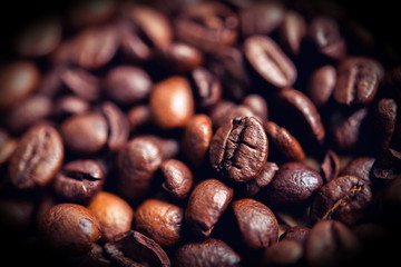 coffee beans on wooden table on brown background