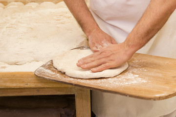 Baker kneading the dough