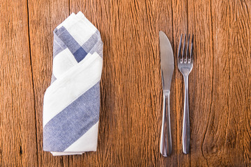Fork and spoon and knife set on table.