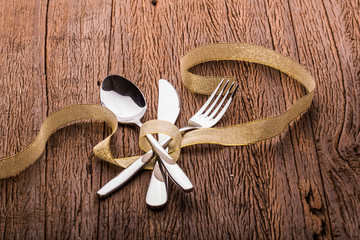 Fork and spoon and knife set on table.