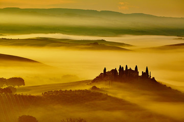 Scenic Tuscany landscape with rolling hills and valleys in golde