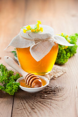 Pot of honey and wooden stick