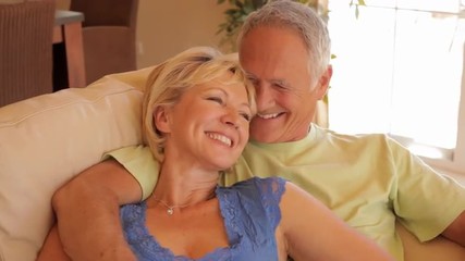 dolly shot of senior couple relaxing on sofa  - Powered by Adobe