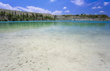 Flooded stone quarry. Crimea. Skalistoe village, Bakhchisaray region. Lake in quarry.