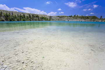Flooded stone quarry. Crimea. Skalistoe village, Bakhchisaray region. Lake in quarry.