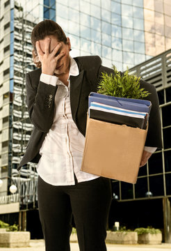 Angry Business Woman carrying Cardboard Box fired from Job 