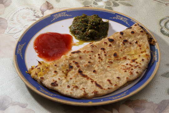 Indian breakfast - Parantha with tomato sauce and green "chutney