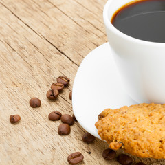 Cup of ecpresso with cookies on old wooden table