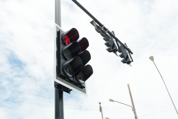 Red color on the traffic light with a beautiful blue sky in background