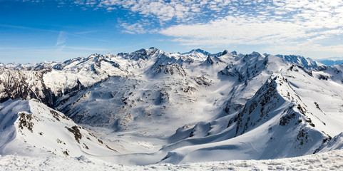 snowy mountain peaks against the blue sky