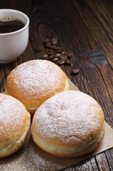 Sweet donuts and coffee cup on table