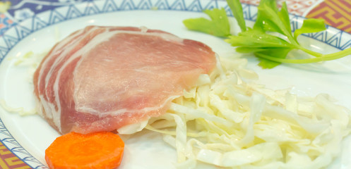 Many fresh pork chops or cutlets with parsley