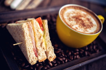 coffee mocha hot and coffee beans on wooden table on brown backg