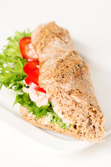 Prawn sandwich on white plate vertical angled
