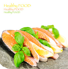 Salmon on stone with basil and lemon isolated on white