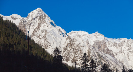 Fototapeta na wymiar Snowy peaks against the blue sky