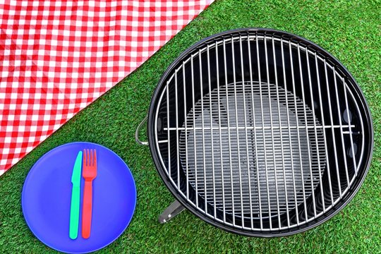 Picnic Tablecloth, Plate, Fork, Knife, BBQ Grill  On The Lawn