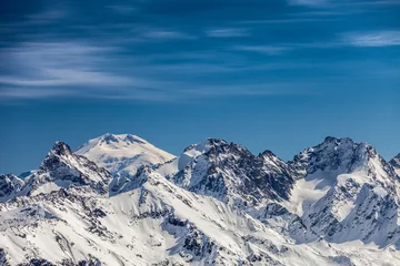 Foto op Aluminium Snowy peaks against the blue sky © Denis Ponkratov