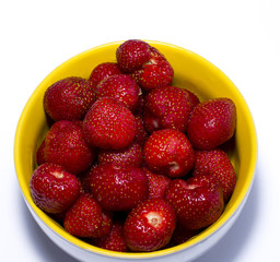 strawberry in a yellow plate a side view