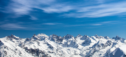 Fototapeta na wymiar Snowy peaks against the blue sky