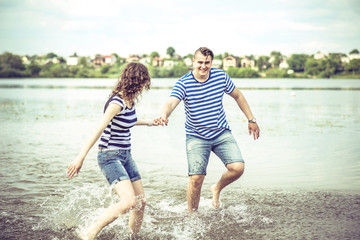 Fototapeta premium Pretty couple outdoor, running on the lake