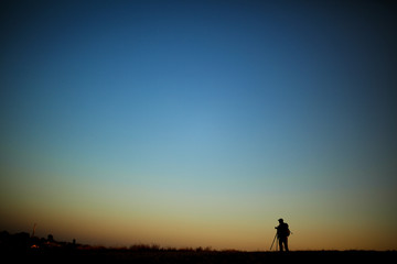 Fototapeta na wymiar Silhouette of a photographer during the sunset.
