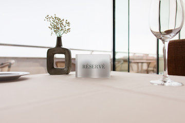 wine glass and flower vase on restaurant table