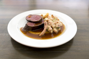 Grilled saddle of deer, grilled octopus, dressing - shallow depth of field