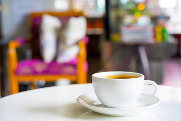 Hot Americano coffee on white table.