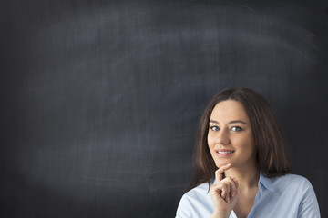 Businesswoman in front of blackboard