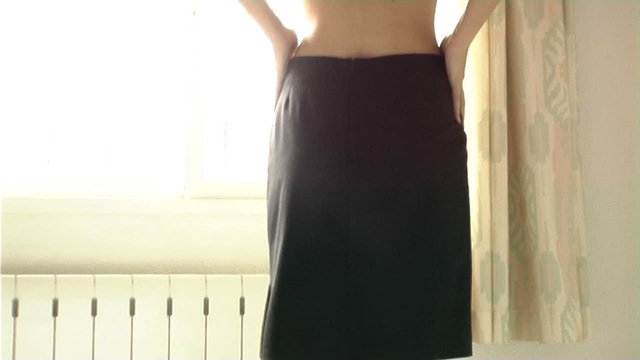 Woman getting dressed in skirt