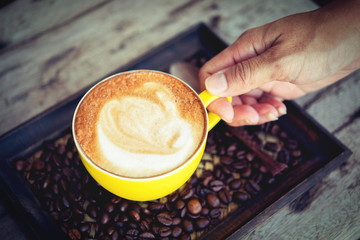 woman holding coffee mocha hot  on wooden table