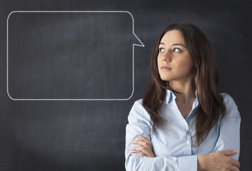 Young woman thinking with blackboard