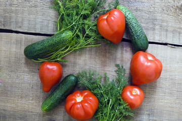 fresh vegetables, cucumbers, tomatoes and fennel on wooden background