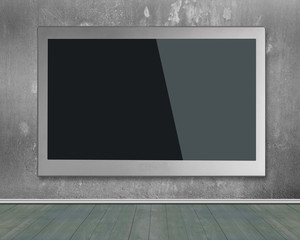 Blank black wide flat TV screen hanging on wall