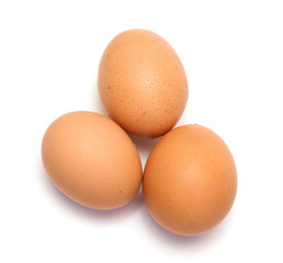 Three chicken eggs on white background