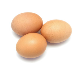 Three chicken eggs on white background